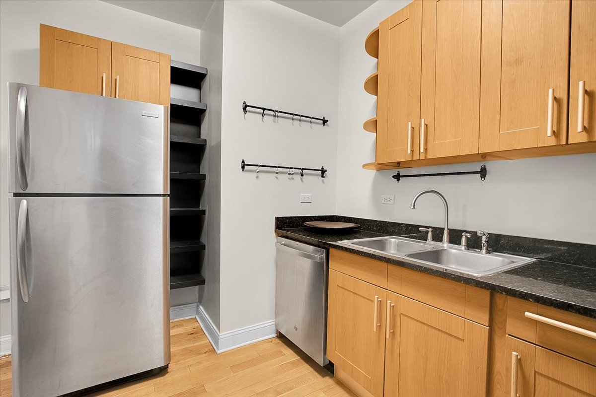 1647 West Sherwin Avenue, Unit 1 Chicago, IL 60626 - Photo 8 of 22 a kitchen with stainless steel appliances granite countertop a refrigerator and a sink