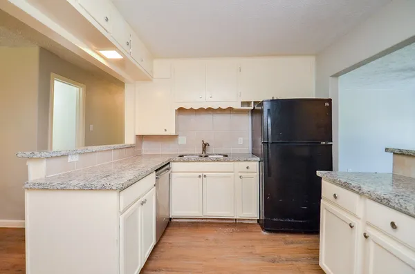 a kitchen with a refrigerator and a sink