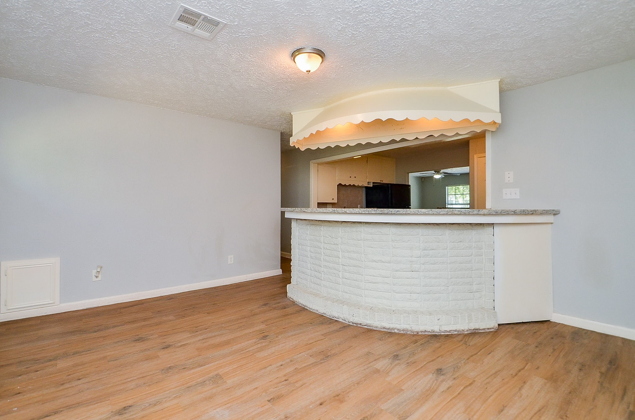 5405 Southlea Street Houston, TX 77033 - Photo 21 of 32 wooden floor with cabinet