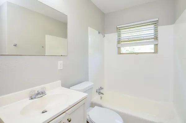 a bathroom with a sink a mirror and a vanity