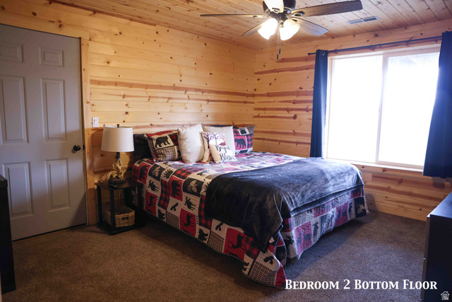 15253 Mill Road, Unit 62 Huntsville, UT 84317 - Photo 5 of 48 Pine wood paneling and ceiling throughout, featuring a ceiling fan with integrated lighting, a large window with privacy curtains, and soft carpet flooring