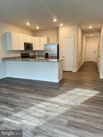 a view of kitchen with refrigerator microwave and stove