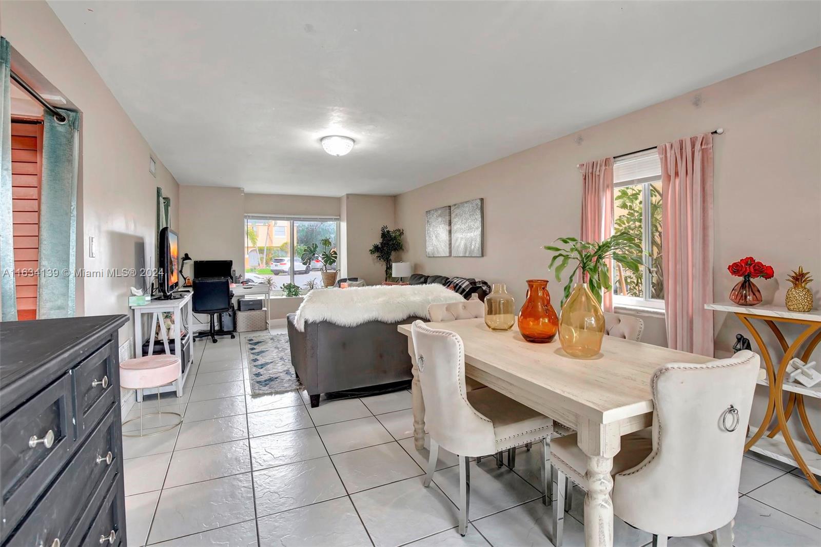 2860 Huron Way Miramar, FL 33025 - Photo 11 of 57 a living room with furniture a dining table and a potted plant