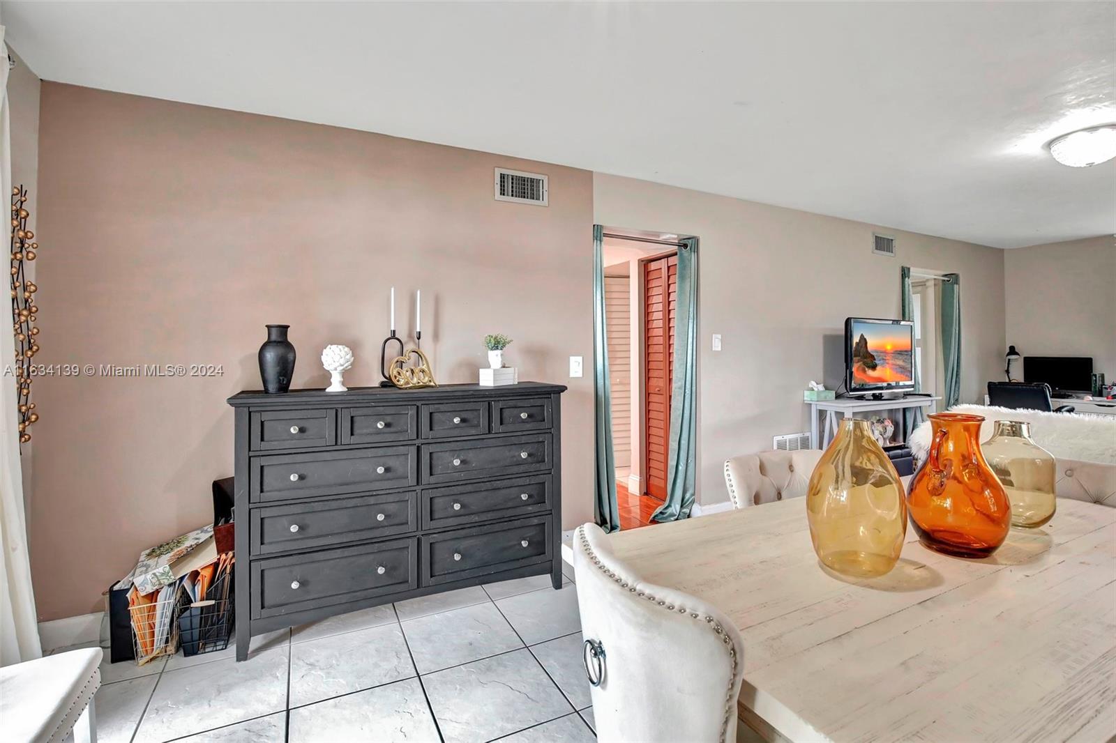 2860 Huron Way Miramar, FL 33025 - Photo 12 of 57 a kitchen with a table and a couch