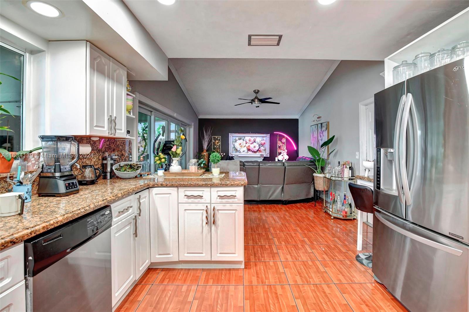 2860 Huron Way Miramar, FL 33025 - Photo 13 of 57 a kitchen with stainless steel appliances granite countertop a refrigerator a stove and a sink