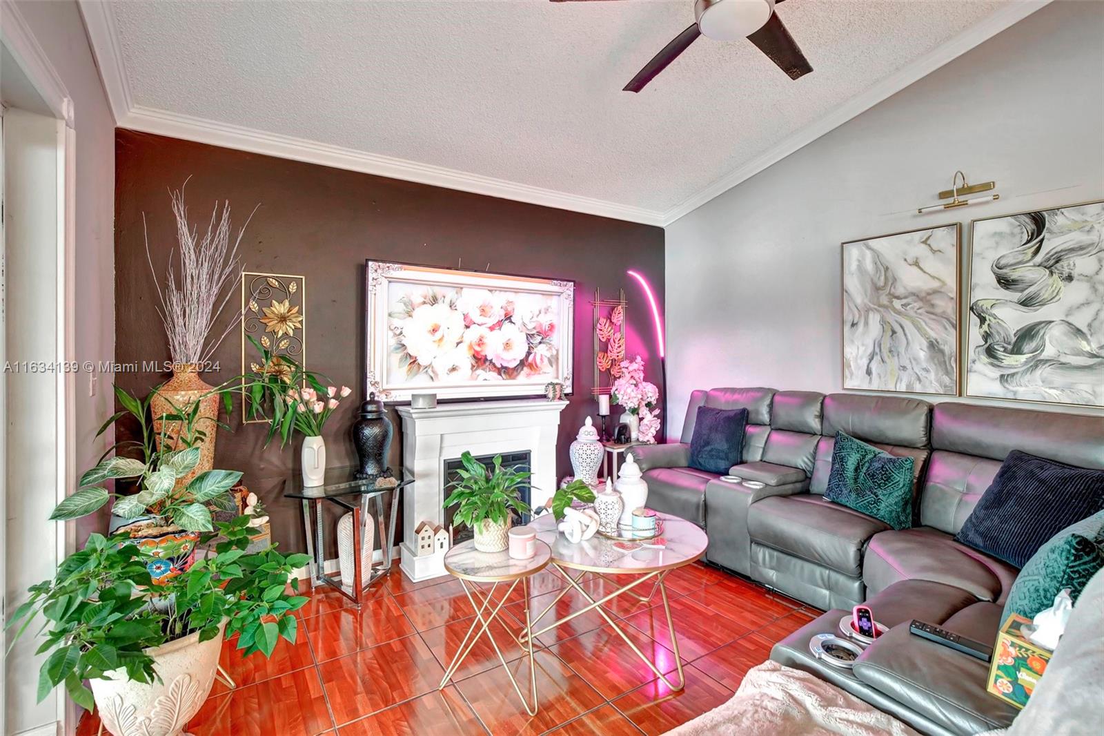 2860 Huron Way Miramar, FL 33025 - Photo 15 of 57 a living room with furniture flowers and a flat screen tv