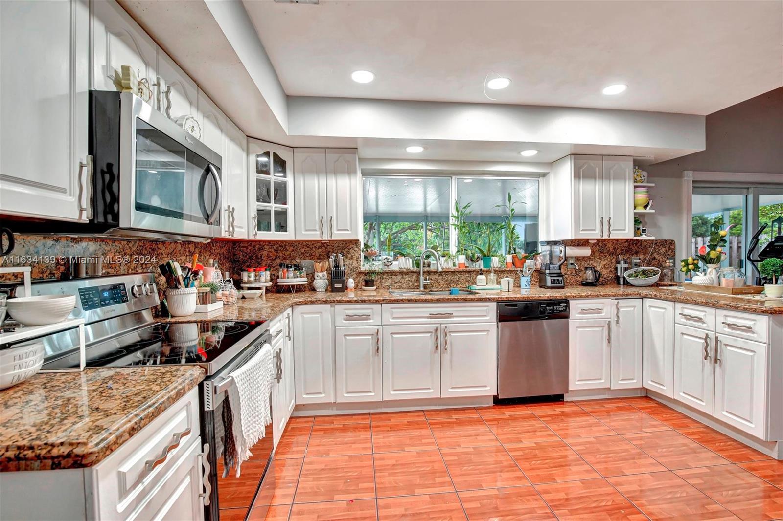 2860 Huron Way Miramar, FL 33025 - Photo 20 of 57 a kitchen with stainless steel appliances granite countertop a sink and cabinets