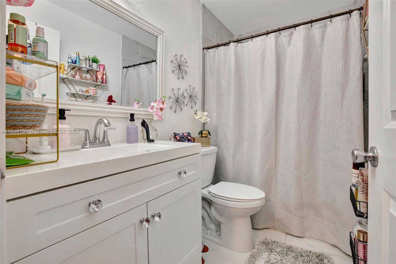 2860 Huron Way Miramar, FL 33025 - Photo 24 of 57 a bathroom with a sink a toilet and shower curtain