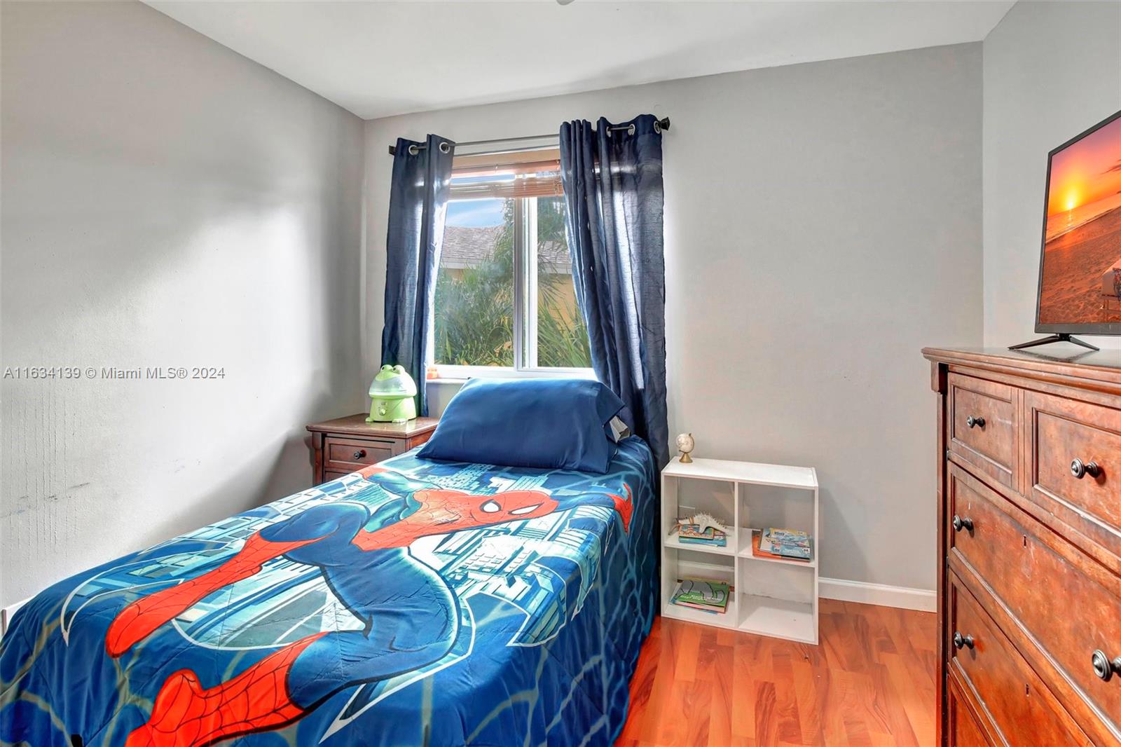 2860 Huron Way Miramar, FL 33025 - Photo 28 of 57 a bedroom with a bed and a flat tv screen on dresser