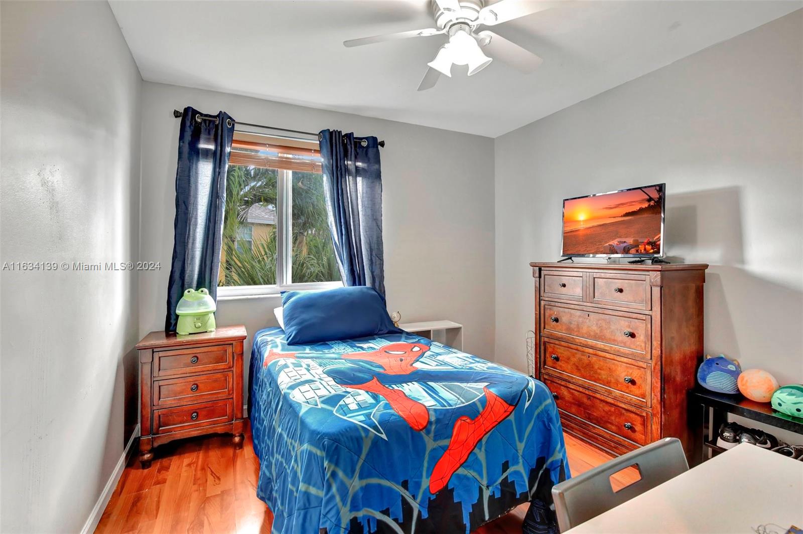 2860 Huron Way Miramar, FL 33025 - Photo 29 of 57 a bedroom with a bed and wooden floor