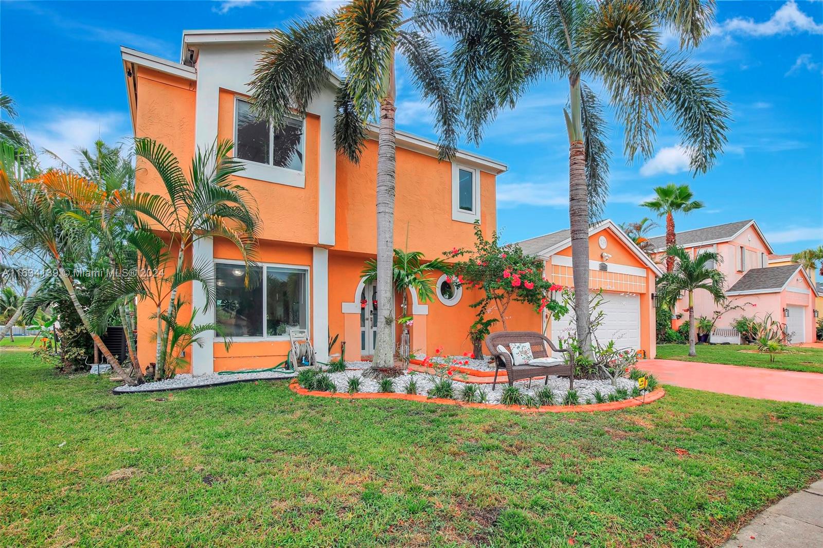 2860 Huron Way Miramar, FL 33025 - Photo 3 of 57 a view of a white house with a big yard and palm trees