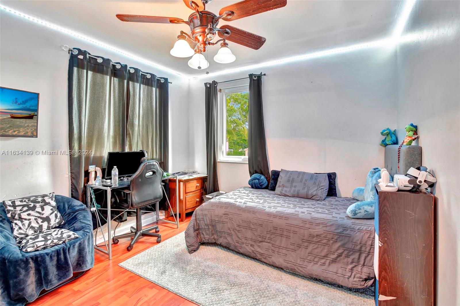 2860 Huron Way Miramar, FL 33025 - Photo 31 of 57 a bedroom with a bed and a chandelier