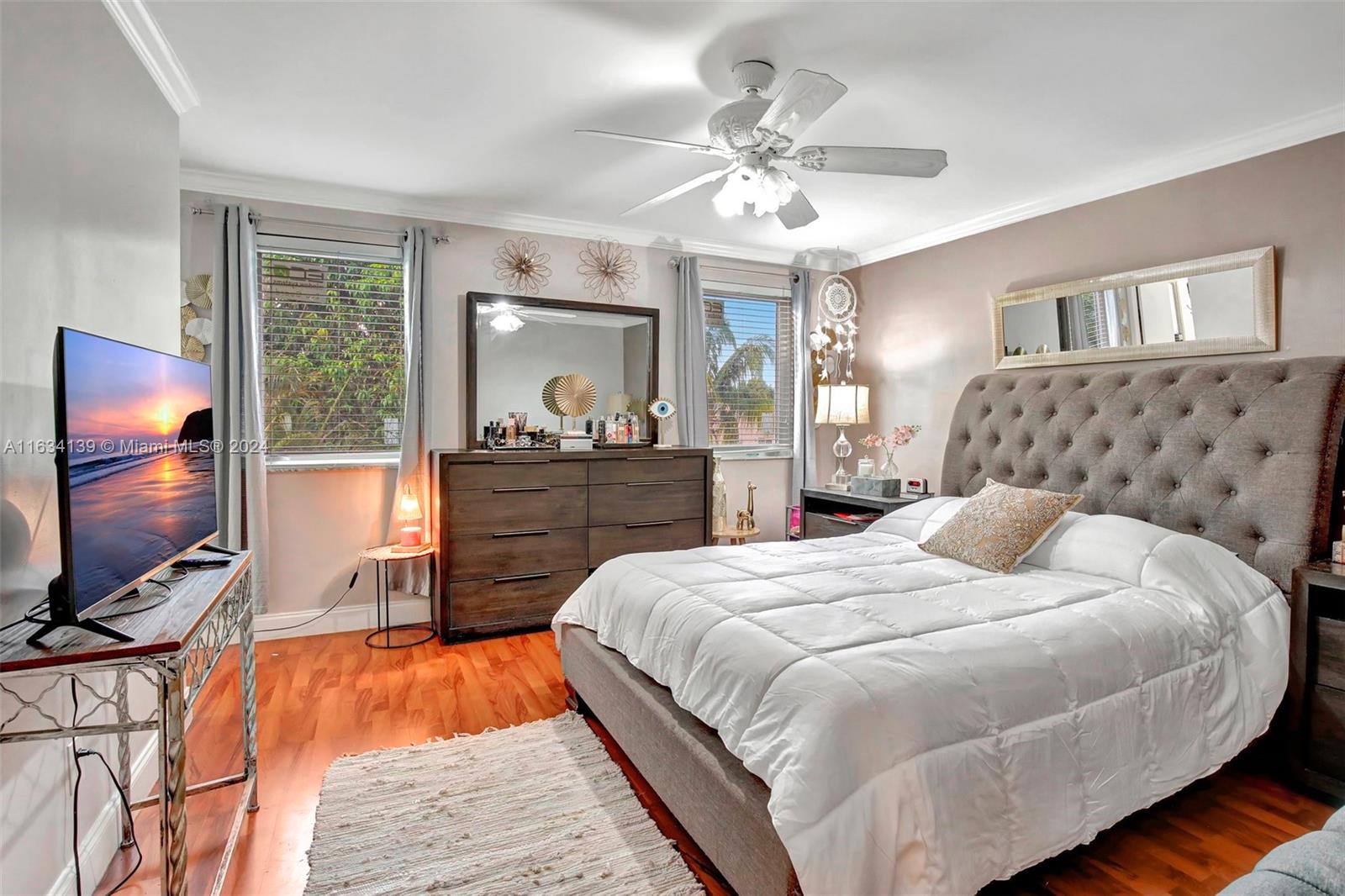 2860 Huron Way Miramar, FL 33025 - Photo 33 of 57 a bedroom with a large bed and a flat tv screen on dresser