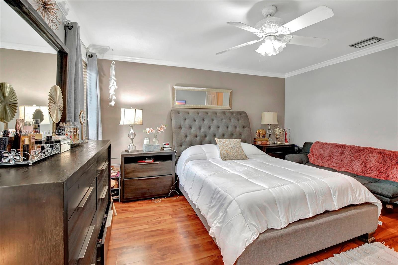 2860 Huron Way Miramar, FL 33025 - Photo 34 of 57 a bedroom with bed and a chandelier