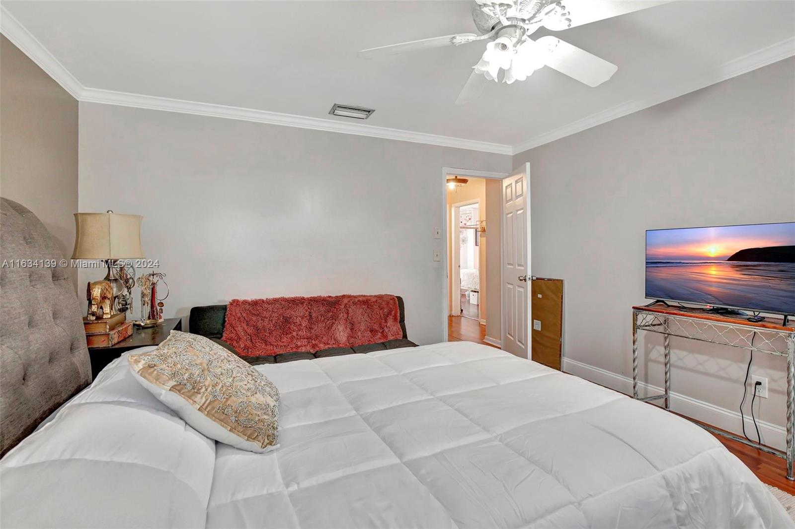 2860 Huron Way Miramar, FL 33025 - Photo 35 of 57 a bedroom with a bed and a chandelier