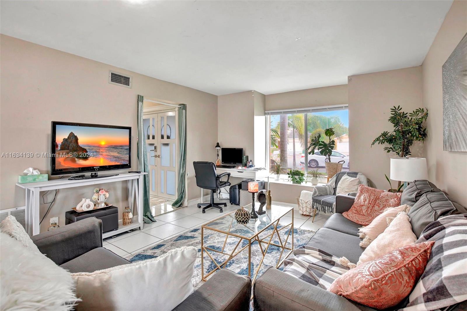 2860 Huron Way Miramar, FL 33025 - Photo 10 of 57 a living room with furniture and a flat screen tv