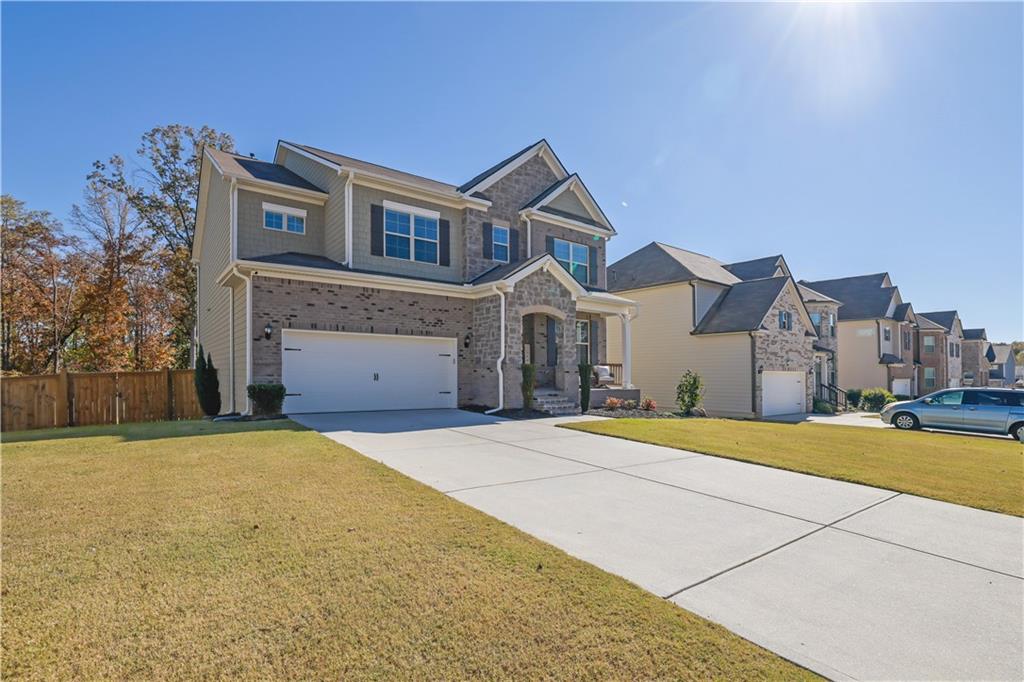 a front view of a house with a yard and a garage