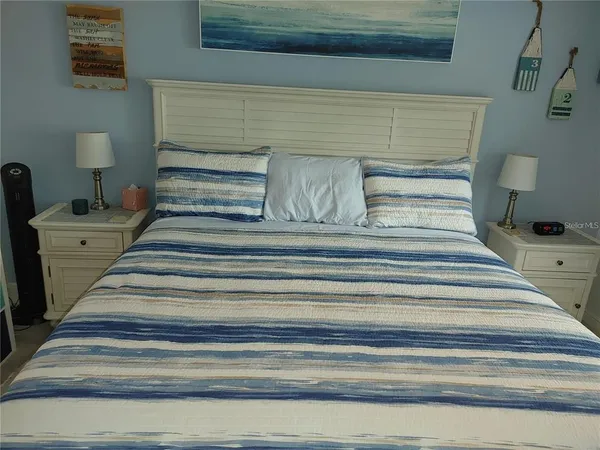 a bedroom with a bed and lamp