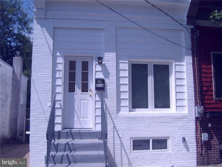 a front view of a house with a red door