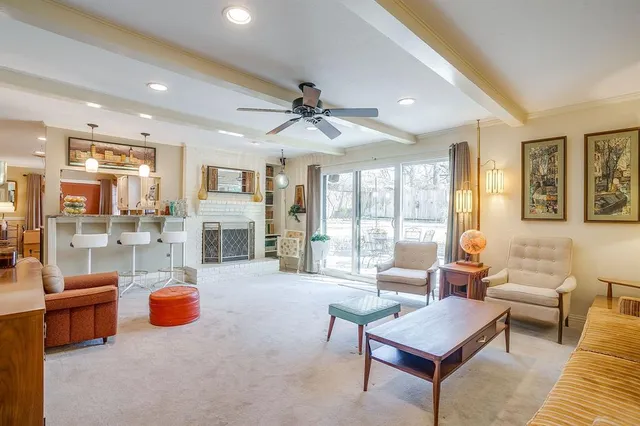 a living room with furniture and a fireplace