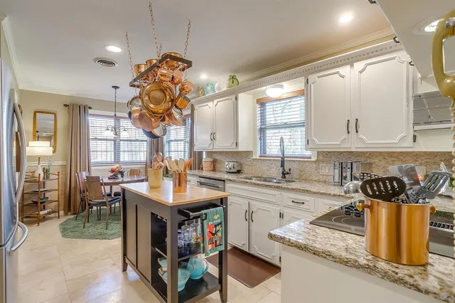 a kitchen with stainless steel appliances granite countertop a sink dishwasher and cabinets with wooden floor