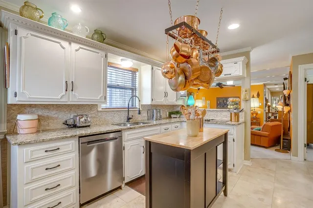 a kitchen with a sink cabinets and window