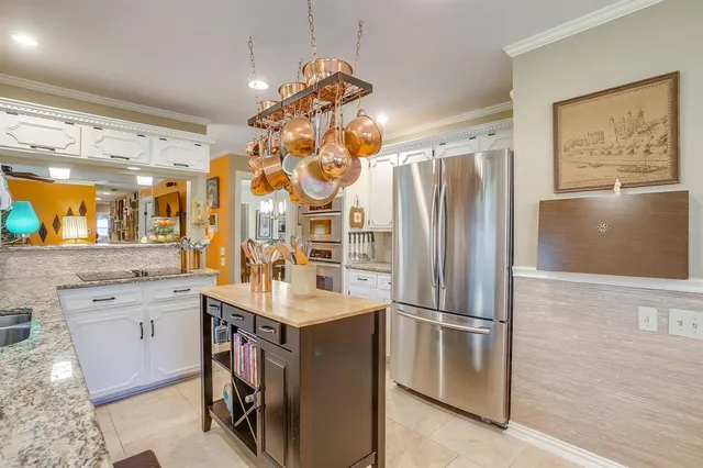 a kitchen with a refrigerator and a sink