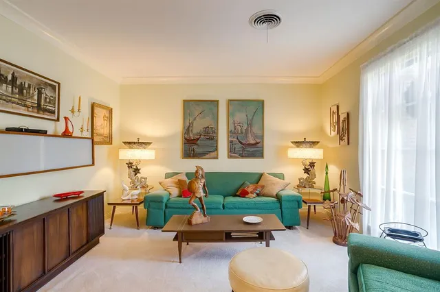 a room with furniture gym equipment and a large window