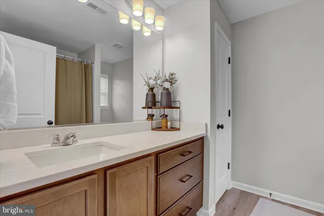 a bathroom with a sink double vanity granite and a mirror