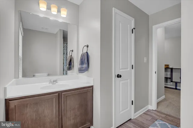 a bathroom with a sink vanity and mirror