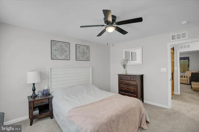a bedroom with a bed and a view of bathroom