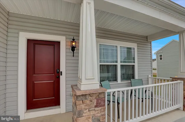 a view of a porch with a door and a window
