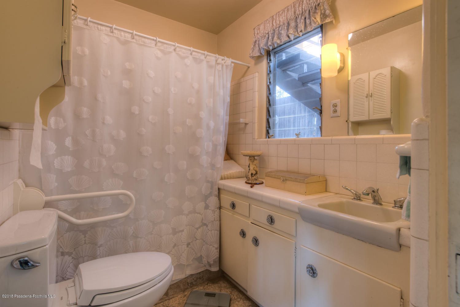 1900 Montecito Drive Glendale, CA 91208 - Photo 19 of 30 a bathroom with a sink a toilet and shower