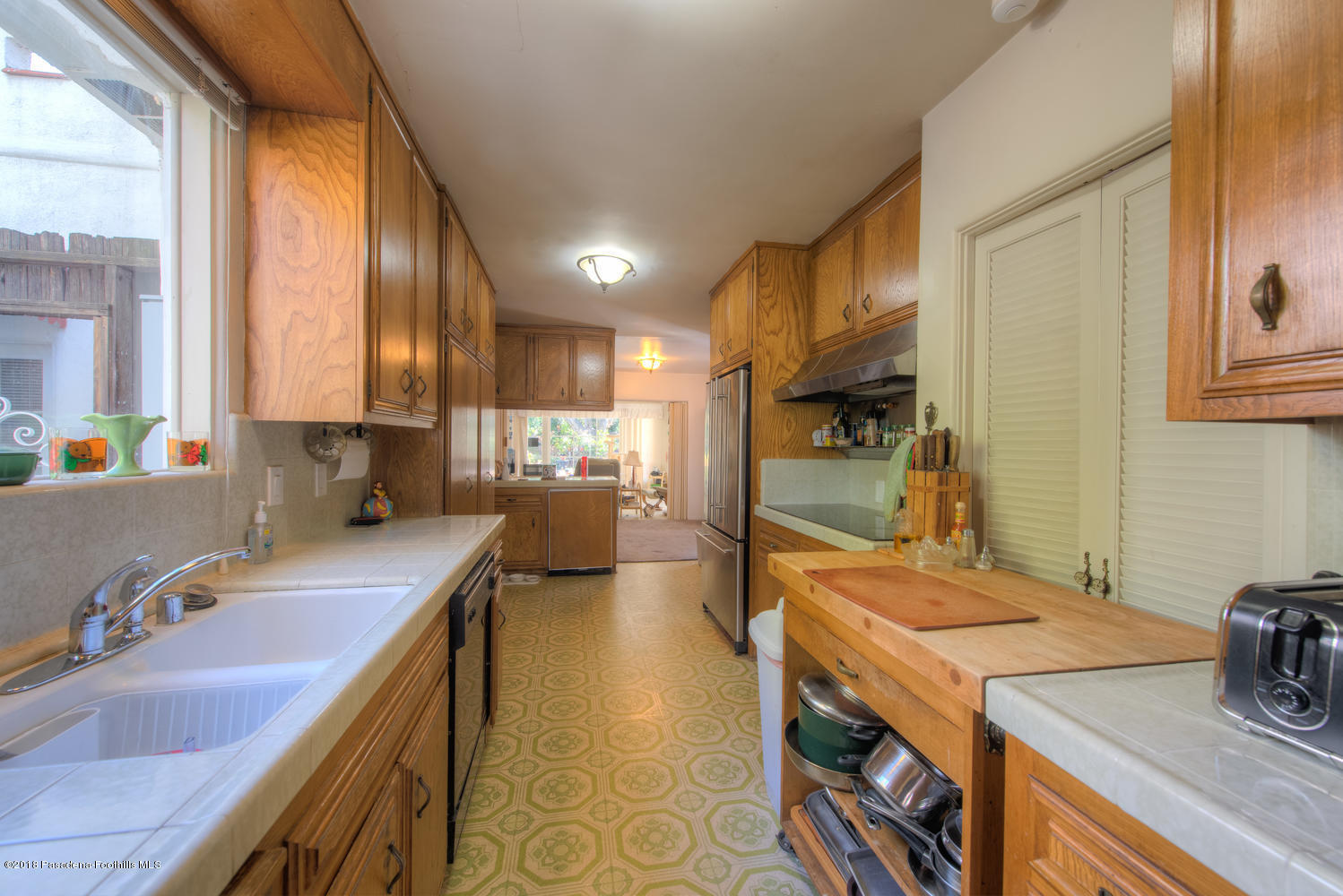 1900 Montecito Drive Glendale, CA 91208 - Photo 6 of 30 a kitchen with a sink stove and cabinets