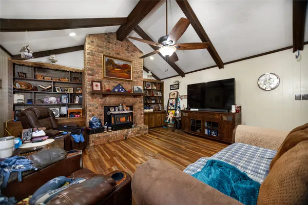 a bedroom with furniture and a flat screen tv
