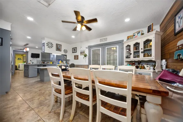 a large kitchen with a table and chairs