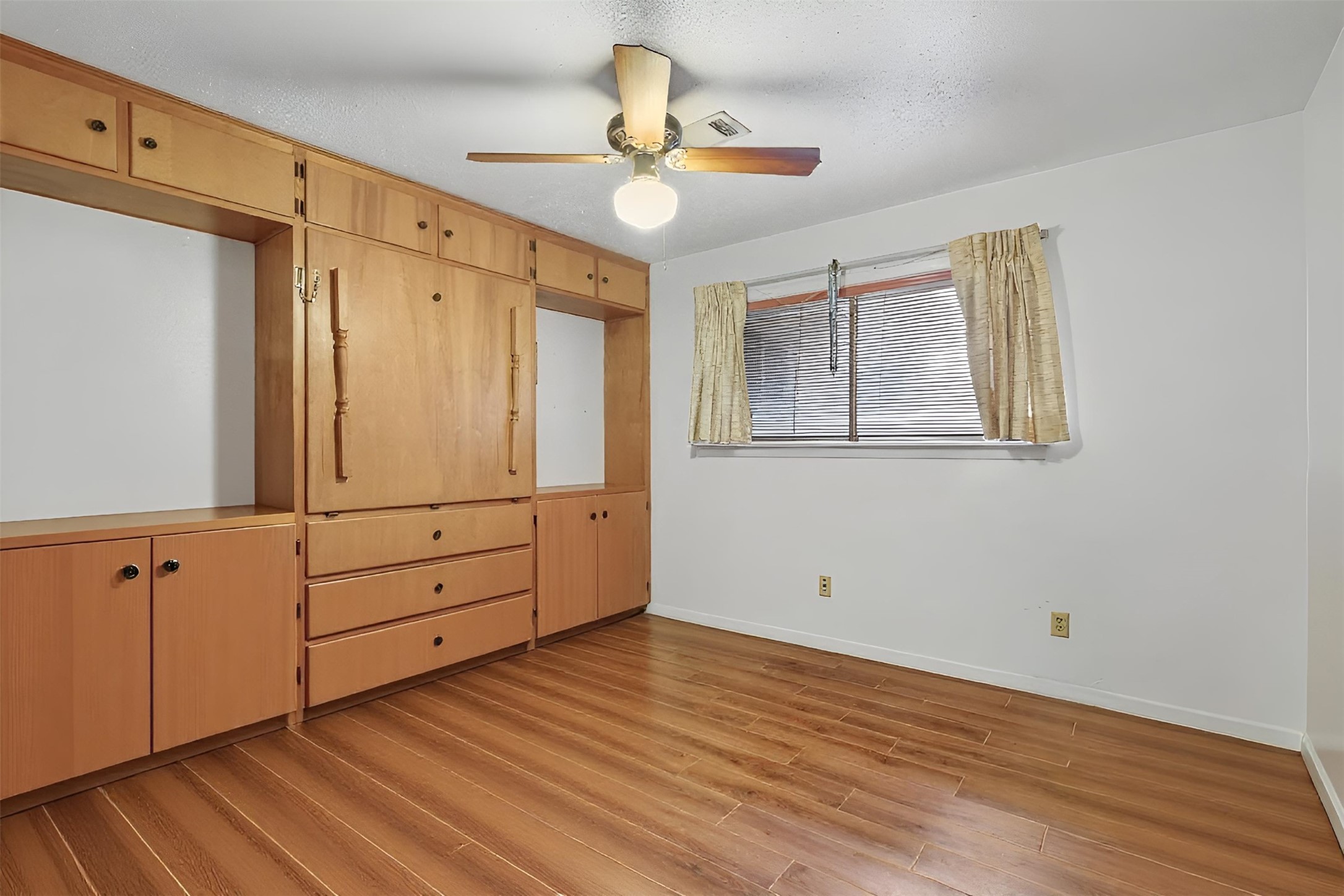 8406 East Mt Houston Road Houston, TX 77050 - Photo 18 of 30 an empty room with wooden floor cabinet and windows
