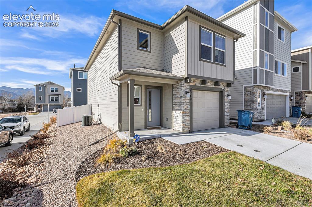 2940 Magic Carpet Loop Colorado Springs, CO 80916 - Photo 3 of 21 a front view of a house with a yard