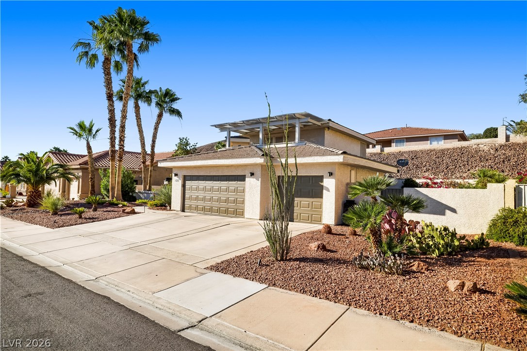 1135 Calico Ridge Drive Henderson, NV 89011 - Photo 3 of 86 A desert-friendly landscape surrounds this residence with attached garages and unique upper-level balcony with amazing views of the strip!