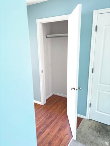 587 West 2400 South Perry, UT 84302 - Photo 22 of 46 Open closet featuring a metal hanging rod and wood-finish flooring