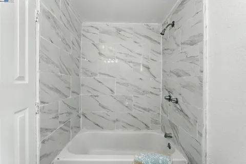 a bedroom with a bed chair and window