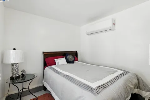 a bedroom with a bed and a mirror