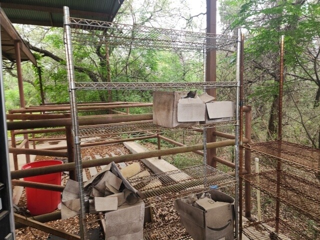 12011 Buckner Road Austin, TX 78726 - Photo 23 of 40 An outdoor storage area offers practical utility amidst the natural surroundings.