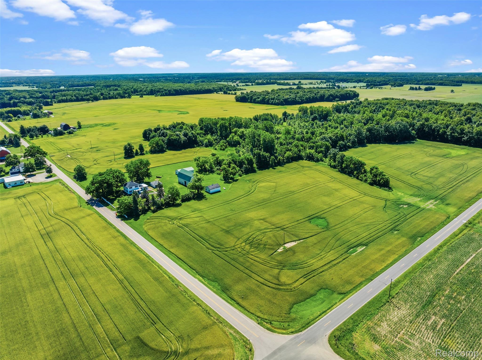 5843 West Dewey Road Owosso, MI 48867 - Photo 51 of 58 Expansive rural property featuring a main residence, multiple outbuildings, and acres of green fields