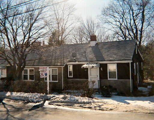 399 High Ridge Drive Bridgeport, CT 06606 - Photo 1 of 1 a front view of a house with a yard covered with snow and trees
