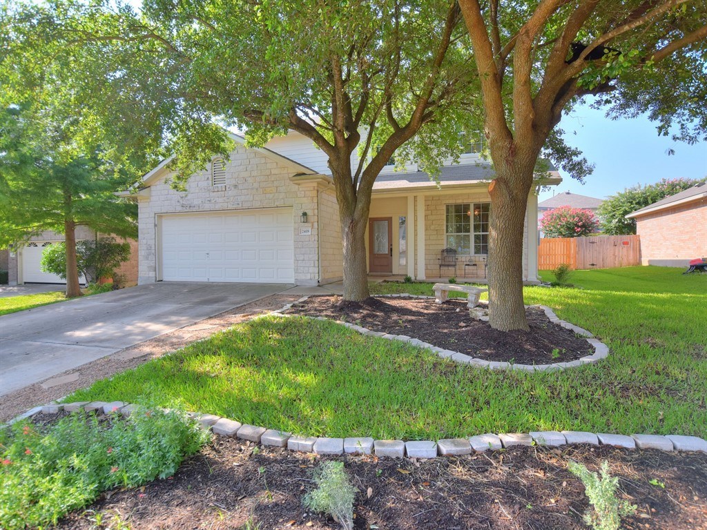 2418 Candle Ridge Trail Georgetown, TX 78626 - Photo 1 of 1 a front view of house with yard and green space