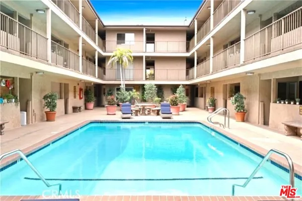 a swimming pool with outdoor seating
