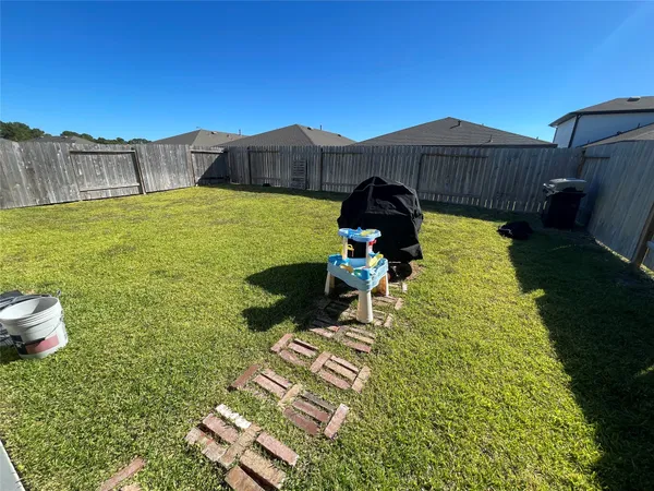 a view of a garden with a house