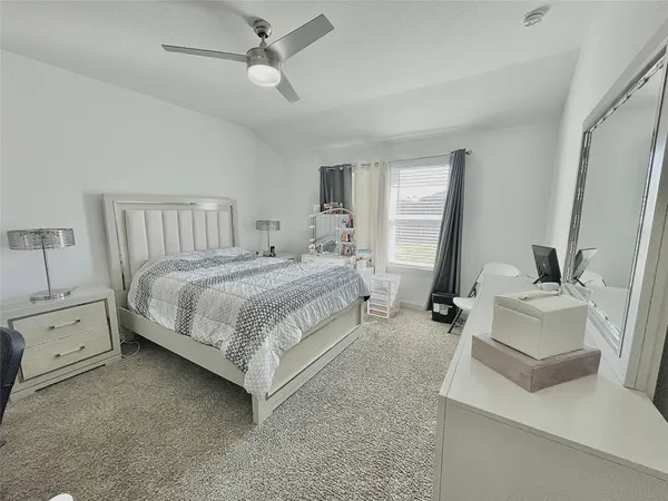 a bedroom with a bed and a couch