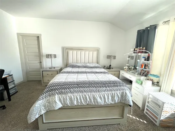 a bedroom with a bed and a table in it